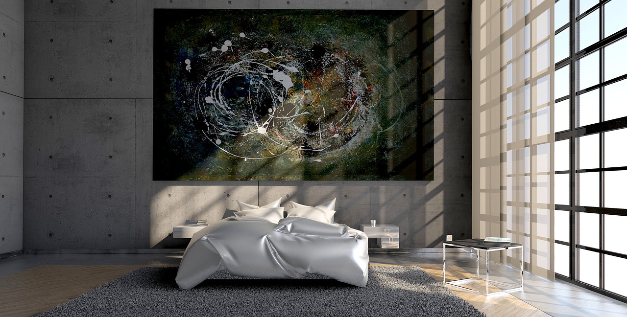 Herfstbladeren schilderij naast een comfortabel bed.